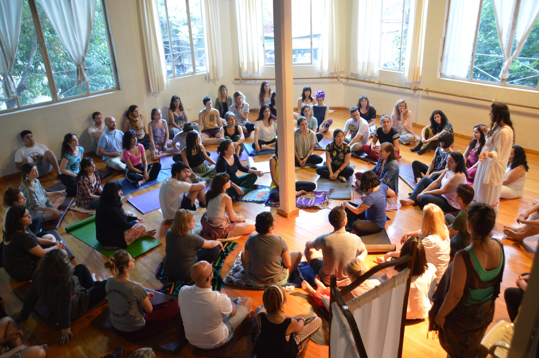 Círculo grande de personas sentadas en un taller de Reiki Vocal